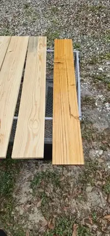 Two planed light wood boards on a stand