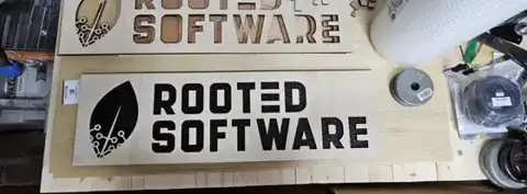 Rooted Software wood sign on the workbench