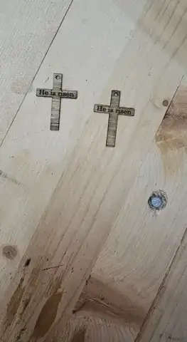 Two cross shapes cut into a light pine board