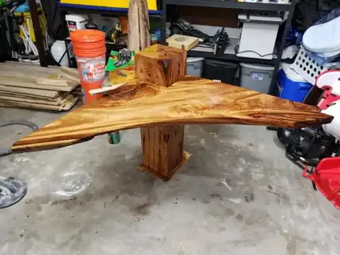 Live-edge corner shelf on a wood post in the garage