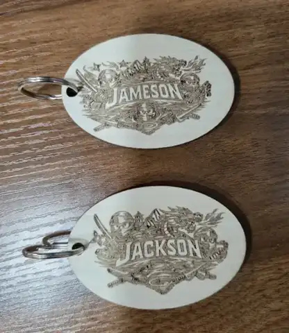 Two oval tags engraved Jameson and Jackson
