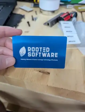 Blue metal Rooted Software card in a hand