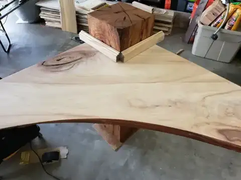 Live-edge corner shelf with a wood block on top