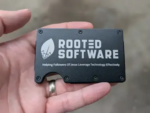 Black metal Rooted Software card wallet in a hand
