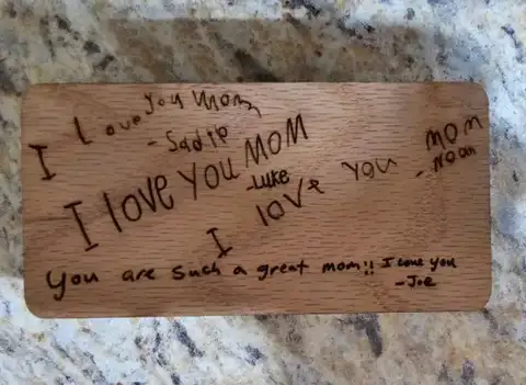Wood tag engraved with a child's handwritten note