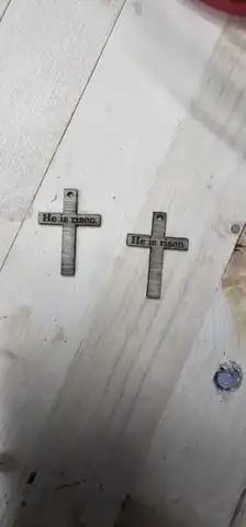 Two cross shapes cut into a pine board