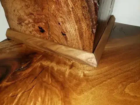 Live-edge shelf joined to a wood post