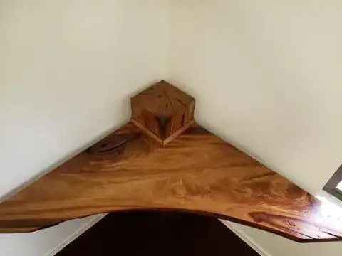 Live-edge corner shelf with a wood block on top
