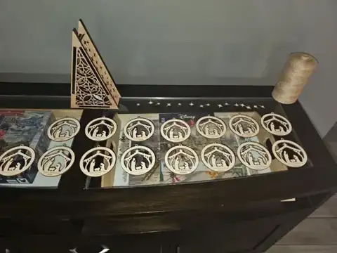 Nativity ornaments and a triangle lantern on a table