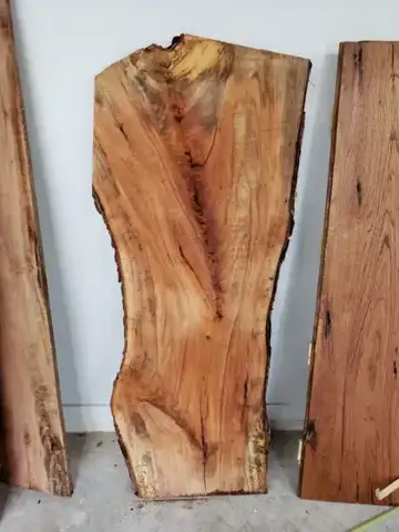 Live-edge slab and boards against a wall
