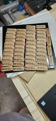 Rows of small engraved wood tags in a tray